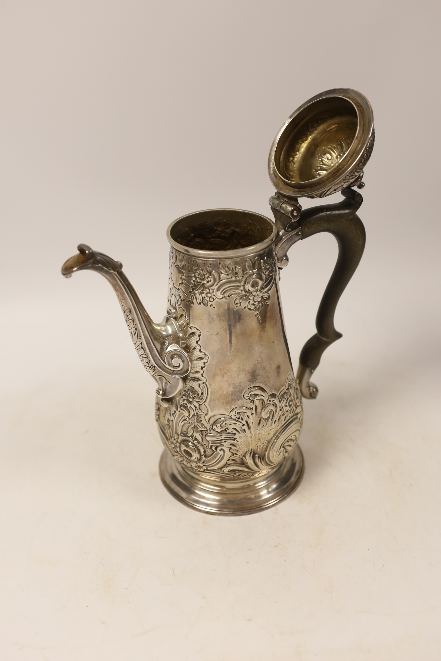 A George II silver coffee pot, with later embossed decoration, by Gurney & Cook, London, 1749m height 23.3cm, gross weight 22.2oz.